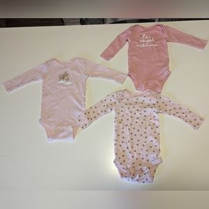 Three matching long sleeved pink onesies